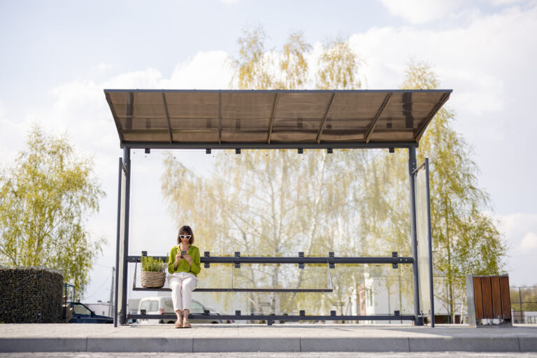A person seeking shade in a city during an extreme heatwave caused by urban heat island effect